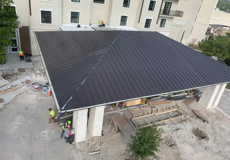 Metal roofing installation team working on a commercial building in Lubbock
